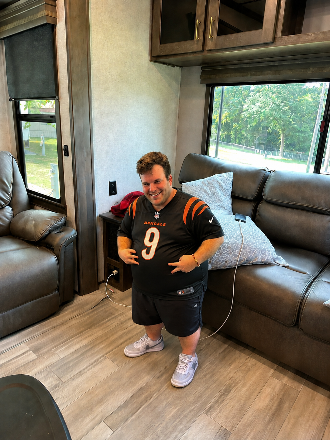 League member posing in a Bengals number 9 jersey inside a camper