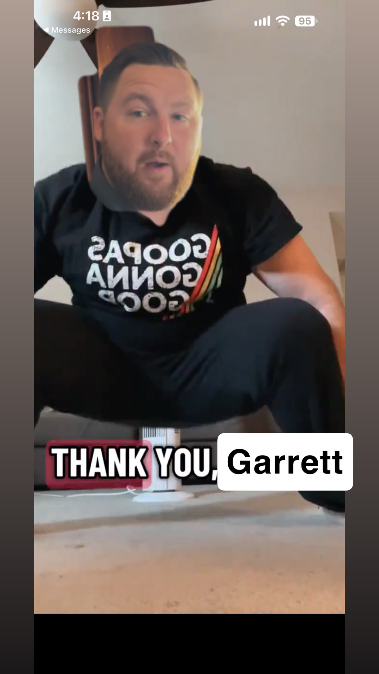 Squatting man in a Goopas Gonna Goop shirt with the caption Thank You, Garrett